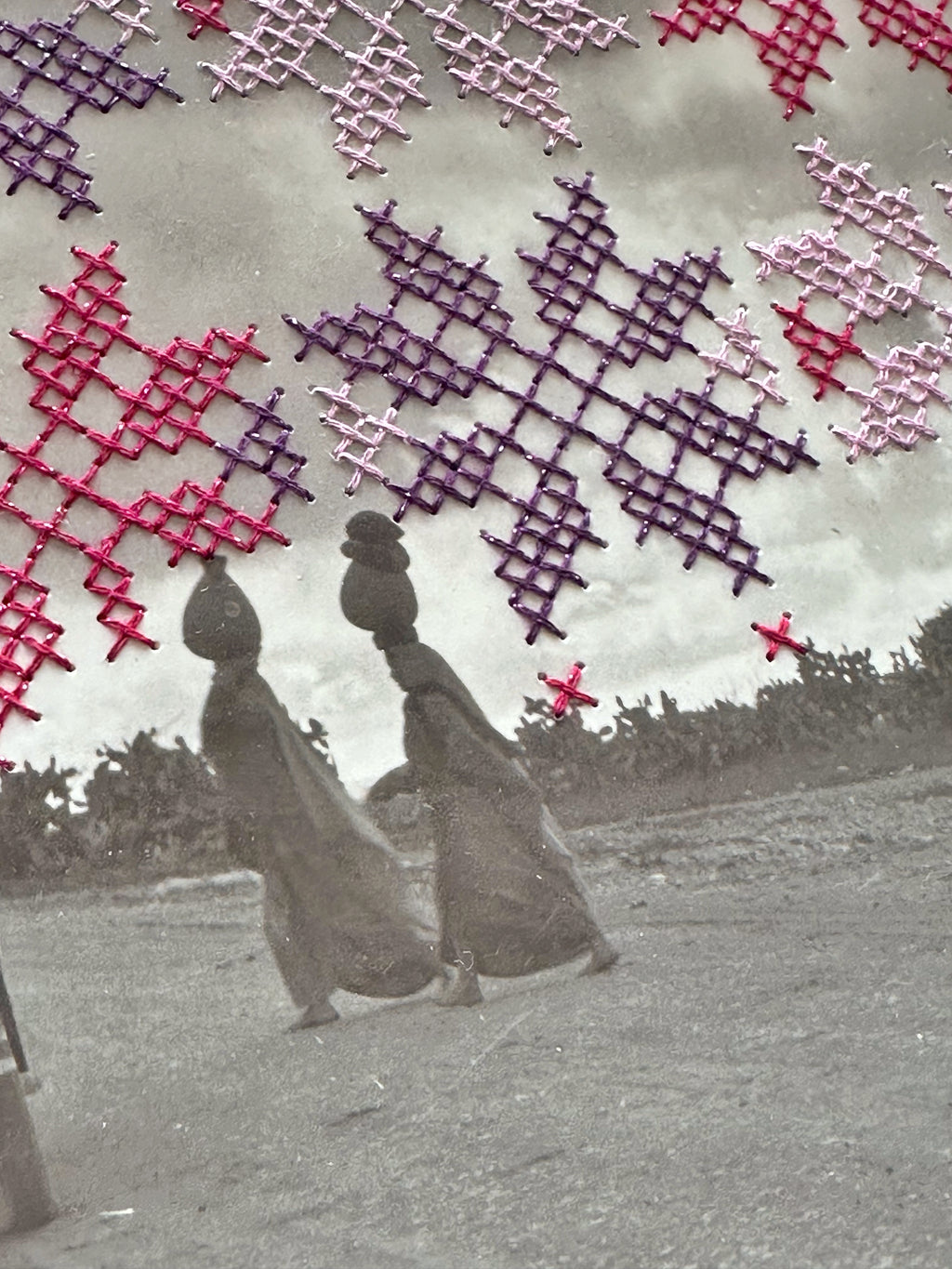 close up of pink and purple tatreez stitched onto black and white photograph 